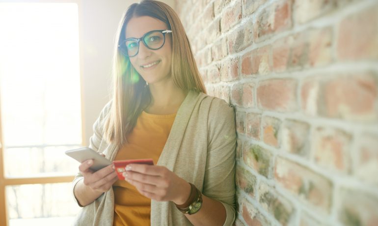 Woman with credit card and smartphone