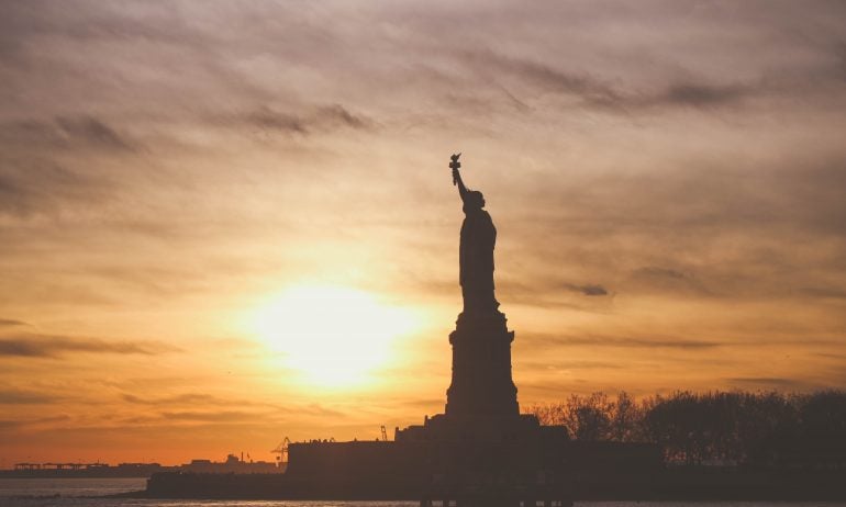 silhouette-of-statue-of-liberty-at-sunrise