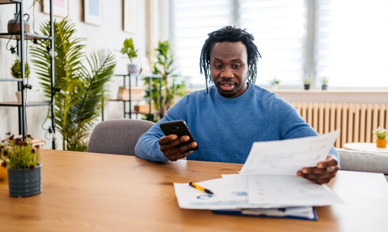 A man reviews financial statements as a part of a wealth management strategy.