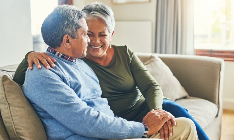 Older couple talking on sofa