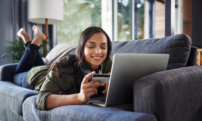 Woman shops online with a credit card