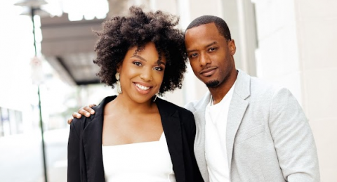 Jhanilka and Anthony Hartzog stand together outside smiling.