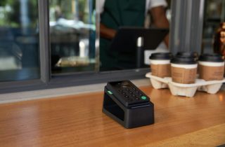 The PayPal Zettle card reader sits on a coffee shop counter.