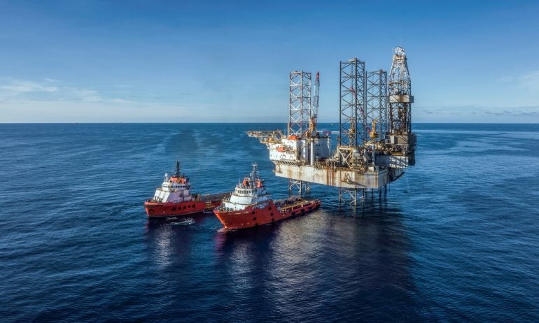 A photo of an offshore oil rig — one of the many types of oil operations one can invest in through oil ETFs.