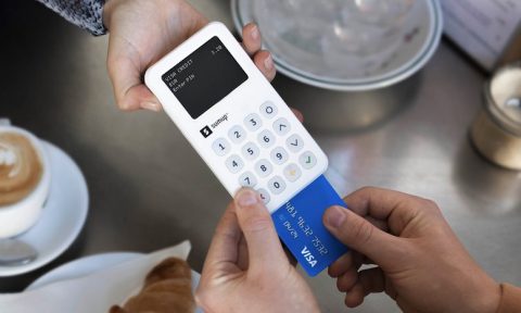 A customer inserts a credit card into the SumUp Pro reader