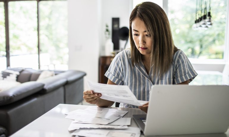 Woman paying bills at home