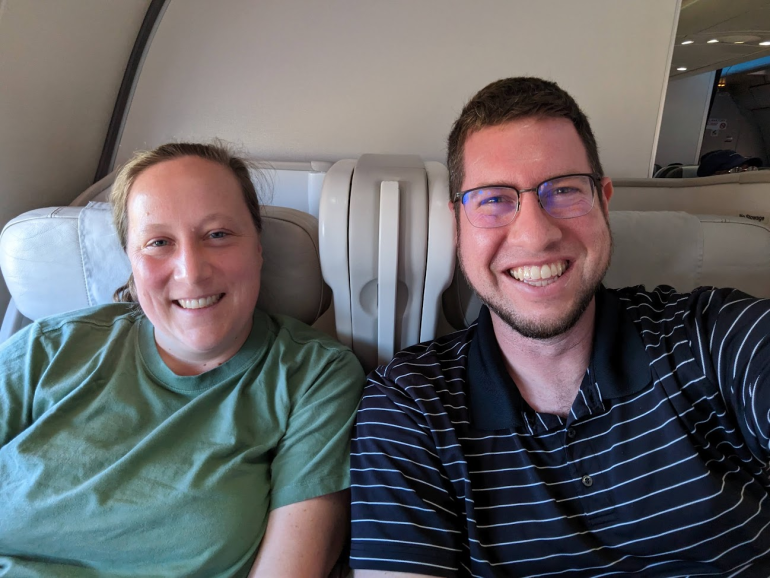 A photo of JT Genter and his wife taking a selfie in their business class seats.