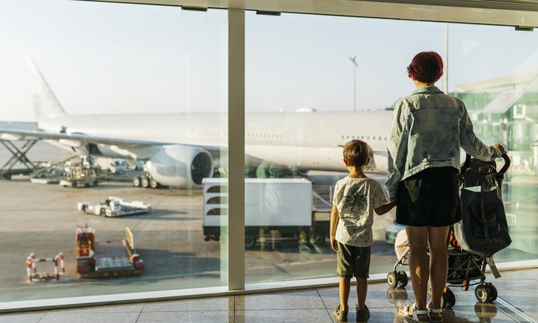 Spain, Barcelona airport, Mother and son waiting in departure area