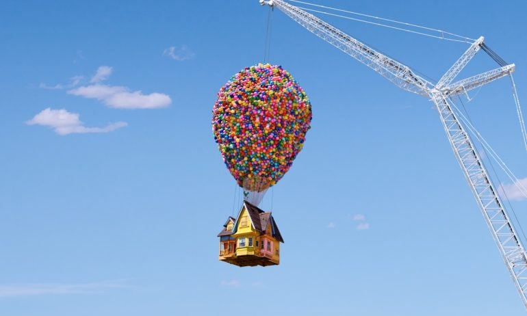 Airbnb's Up house is lifted into the air by crane.