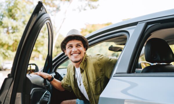 Young man getting out of car