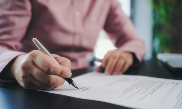 businesswoman signing an official document