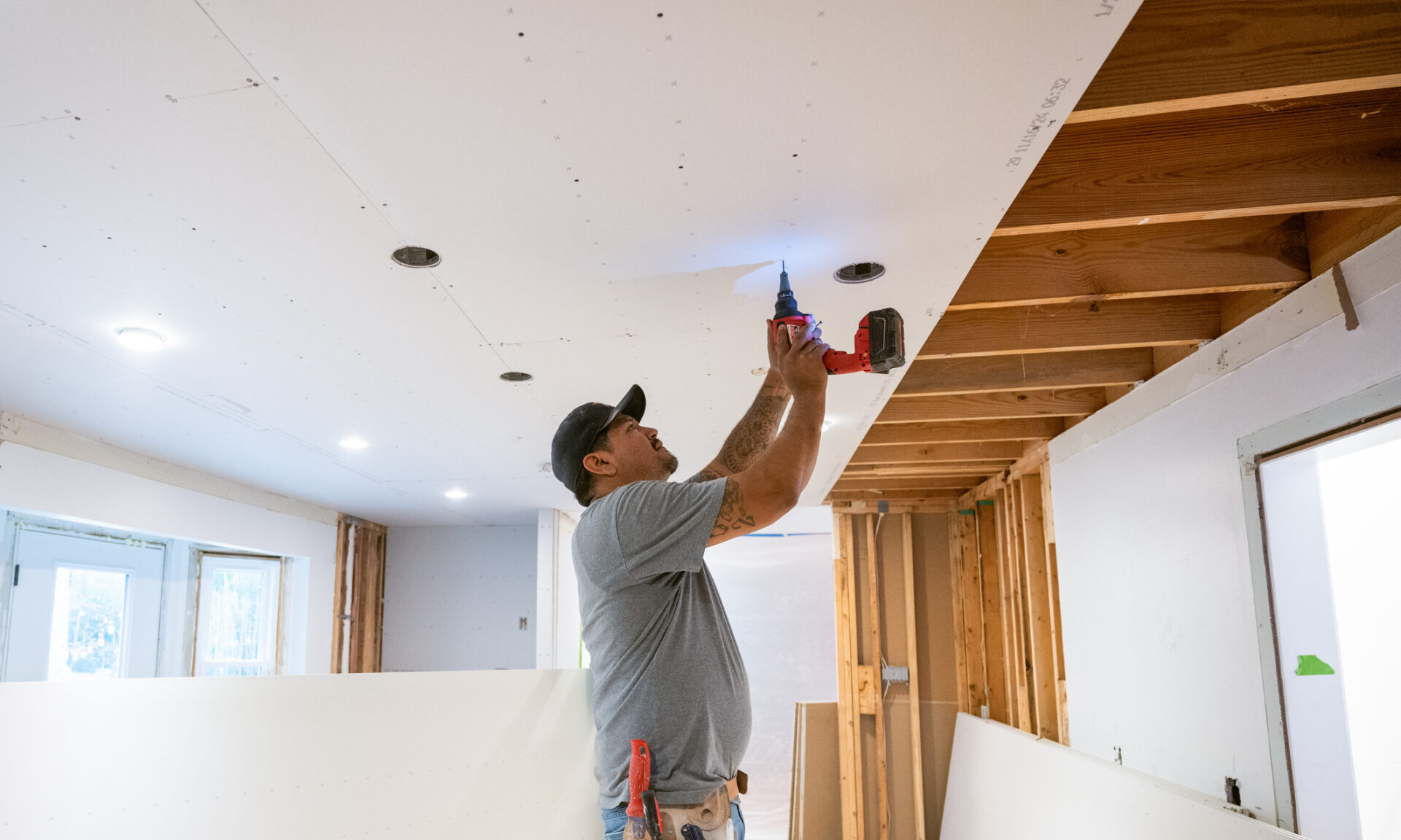 Drywall installers working in an old kitchen renovation