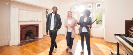 an estate agent shows a couple around a refurbished period home