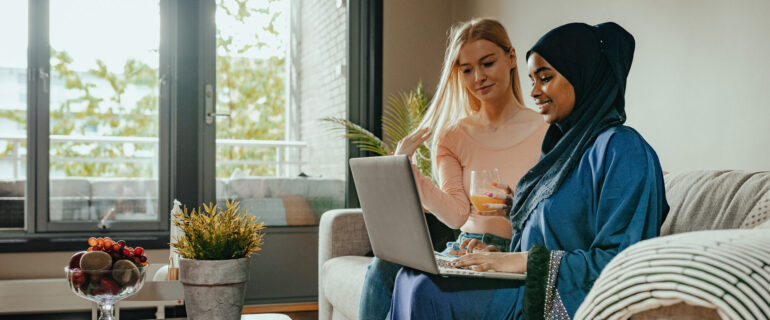 Generation Z women drinking coffee and online shopping with their first credit card.