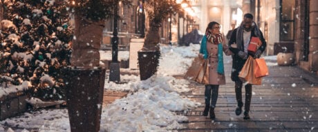 A couple Christmas shopping in snowy weather.