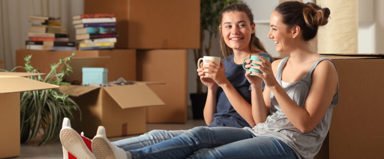 Two roommates celebrate their tenants-in-common mortgage.