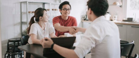 Asian couple celebrates passing the mortgage stress test.