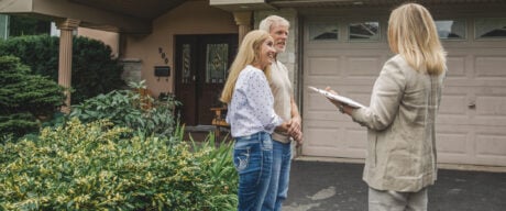 Older couple discusses their joint tenancy mortgage with real estate agent.