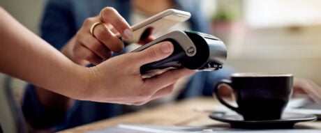 Paying with just a tap using a digital wallet. Closeup shot of a woman paying using NFC technology in a cafe