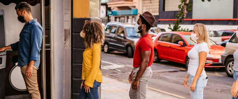 People lined up at an ATM to avoid withdrawal fees.