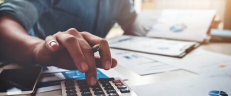 Man at desk calculating his Canadian tax bracket.