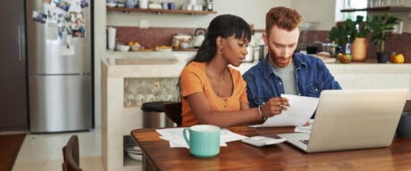 Couple sitting at table researching tax credits in Canada.