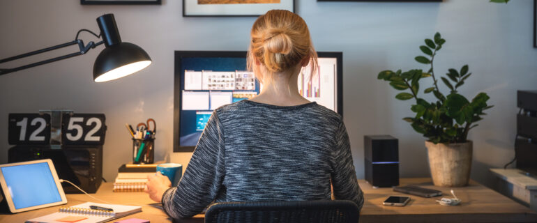 Woman investigates working from home tax credit on her computer.