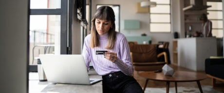 Woman in coffee shop evaluates her use of revolving credit.