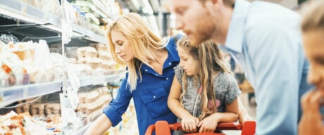 Family shopping together in supermarket during time of high inflation.