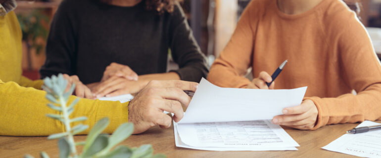 A bank customer making a transaction using a bank draft with a bank teller in a retail bank.