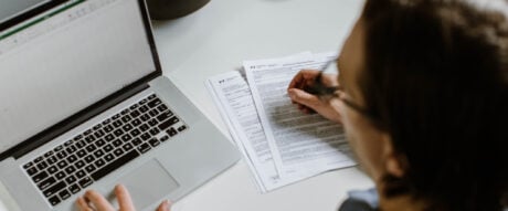 Young professional male filling out tax documents.