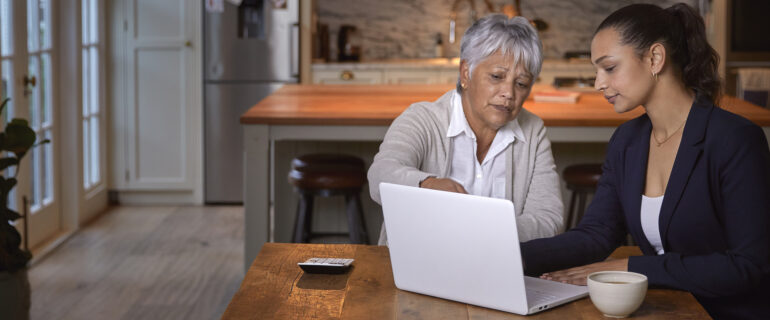 A mature women and younger woman discuss LIFs in front of laptop.