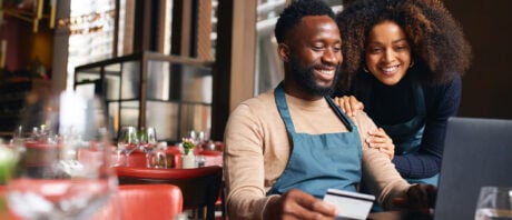 Two restaurant owners make a purchase using their business credit card.