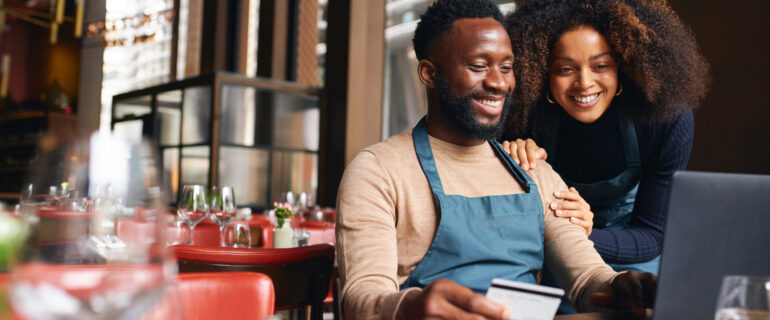 Two restaurant owners make a purchase using their business credit card.