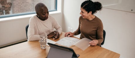 Two women preparing a letter of employment for a mortgage.