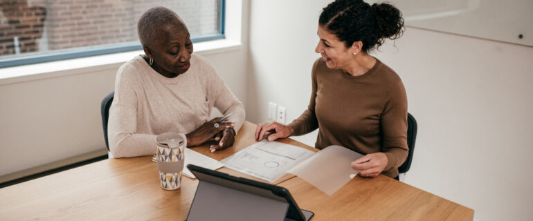 Two women preparing a letter of employment for a mortgage.