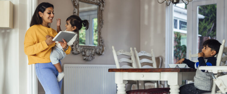 Mother with two children, researching green home grants.