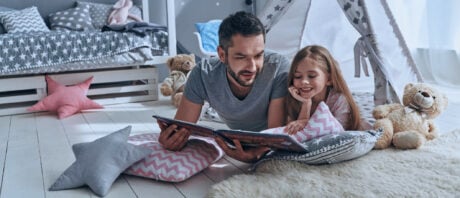 Father and daughter comfortable at home after securing a first-time home buyer grant.