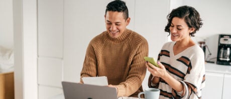 Happy couple discusses how to start investing in Canada.