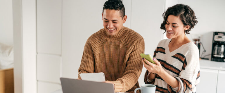 Happy couple discusses how to start investing in Canada.