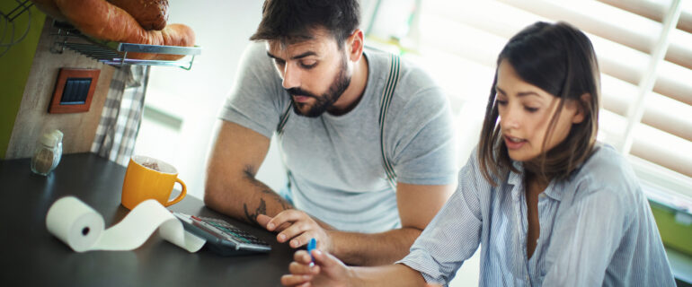 Young couple thinks about credit card debt consolidation.