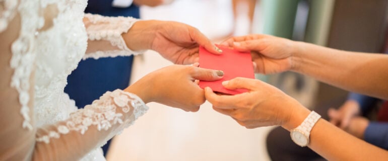 Couple receiving money as a wedding gift.