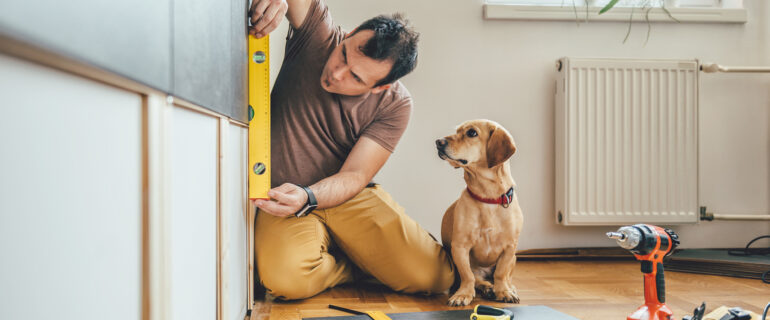 Man and his dog making home upgrades finances with a tax refund.