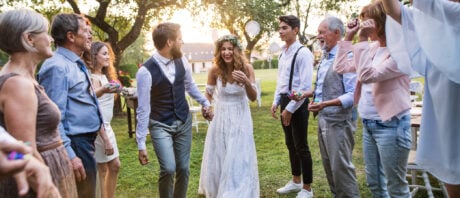 Bride, groom and guests celebrating at their outdoor micro wedding.