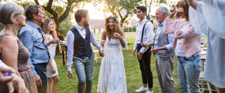 Bride, groom and guests celebrating at their outdoor micro wedding.