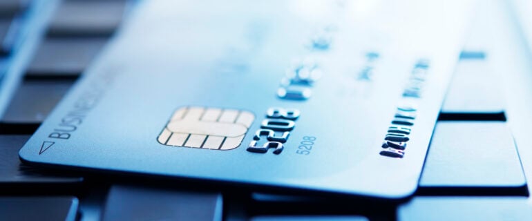 Blue tinted closeup shot of a credit card number.