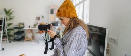 A young female freelance photographer tests her new camera.