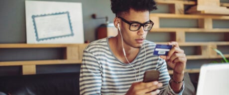 A boy activating his student debit card through his phone.