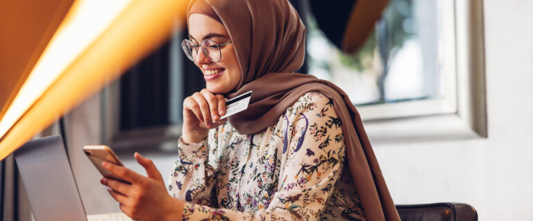 Middle eastern girl checking her bank account number on the digital void cheque