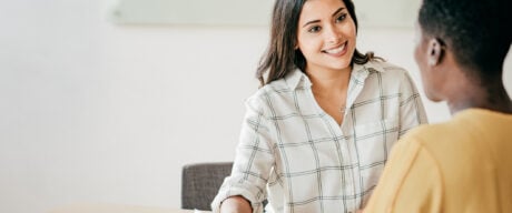 A female financial advisor discussing a client's finances.